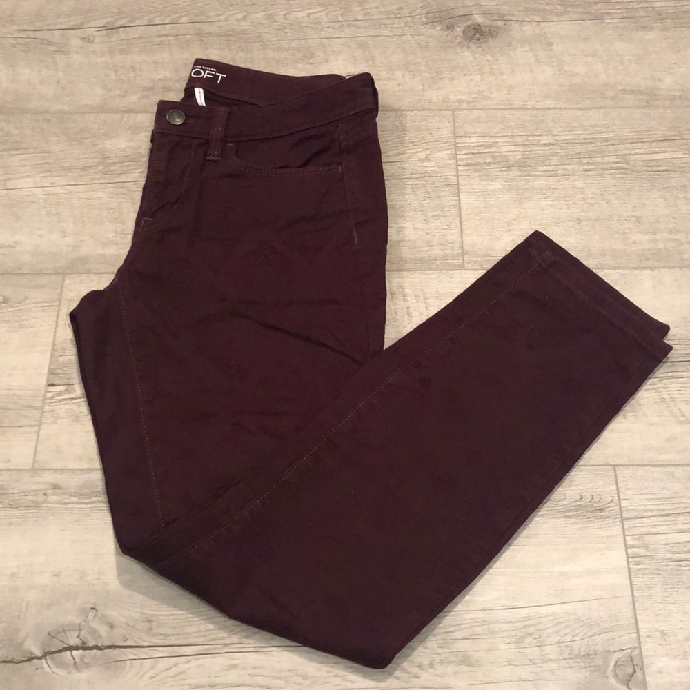 Burgundy patterned skinny pants.